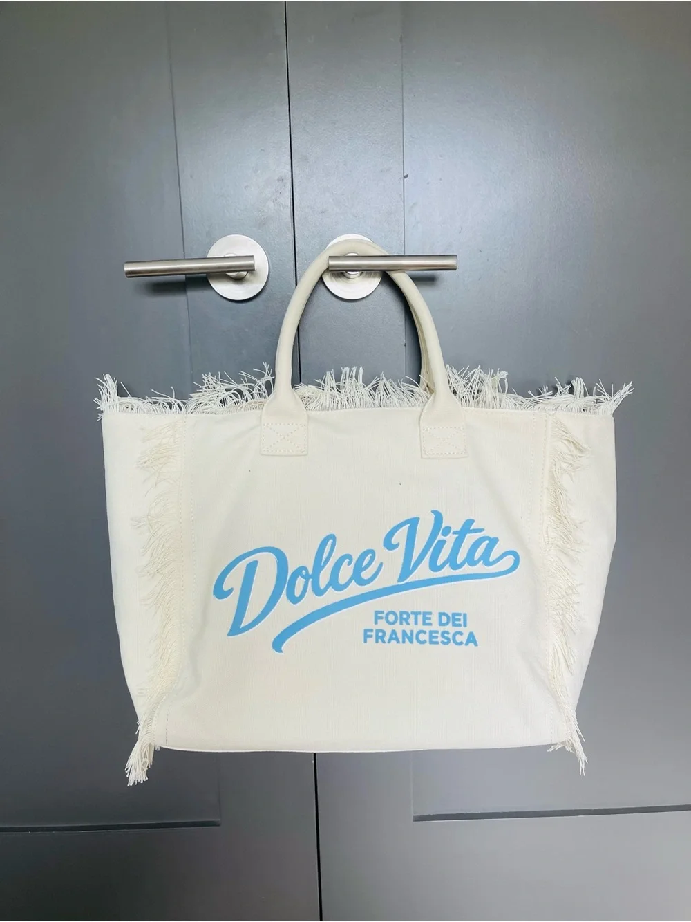 Dolce Vita Cream Canvas Fringe Tote with Light Blue Logo